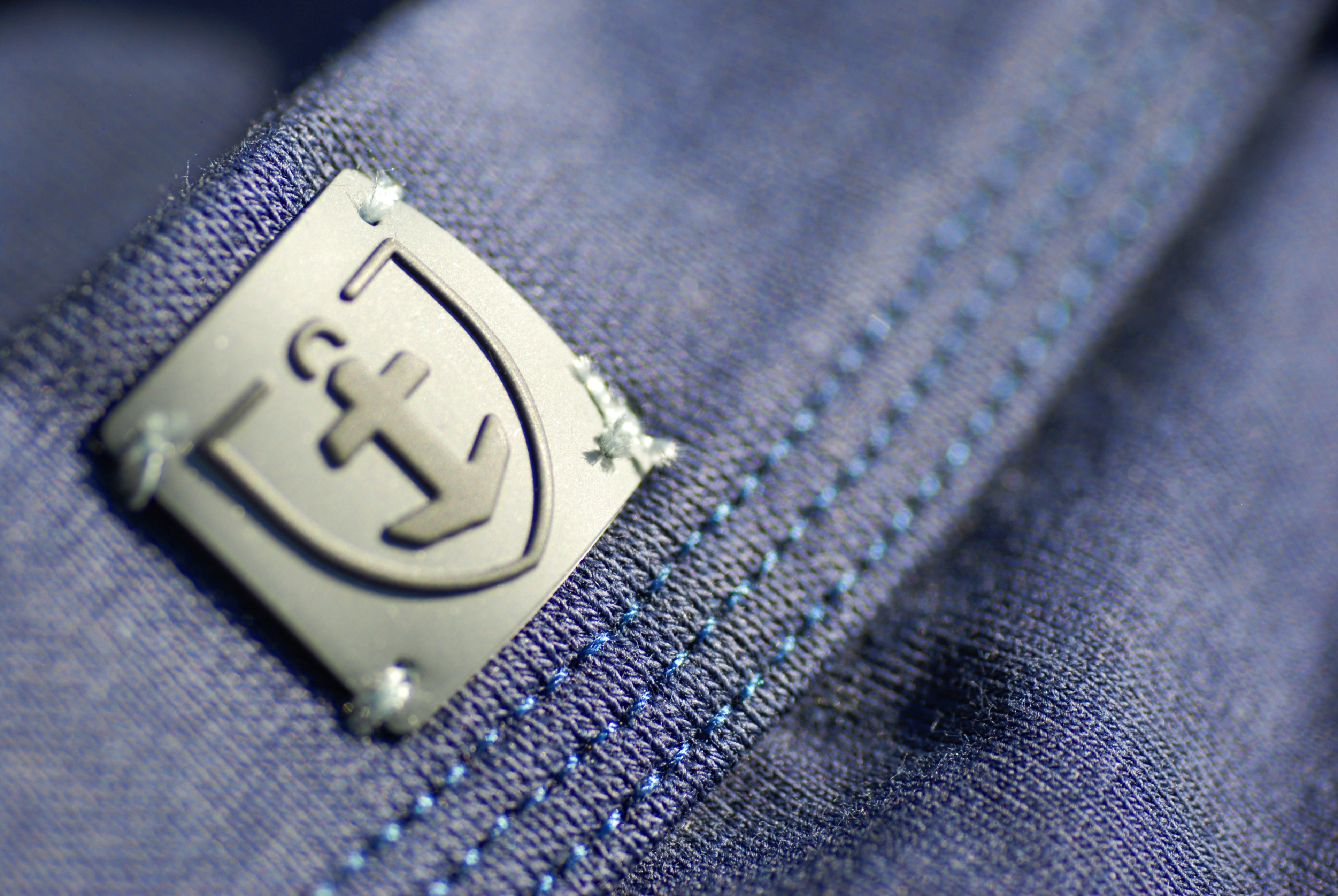 Détail du logo sur le shorty ceinture bleu marine.